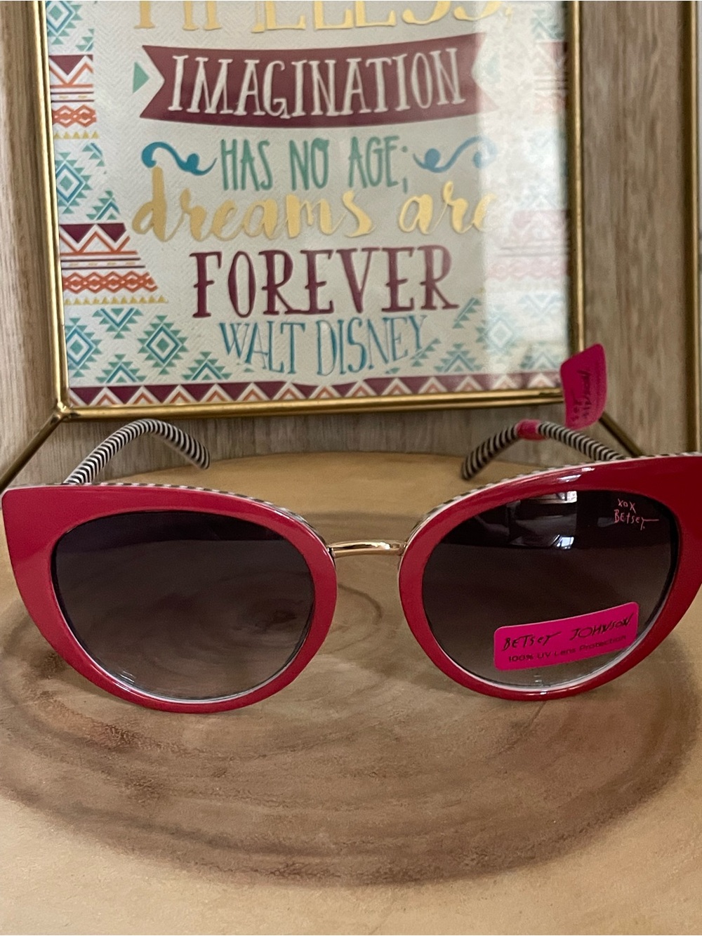 Betsey Johnson hot pink cat-eye sunglasses with black and white striped details